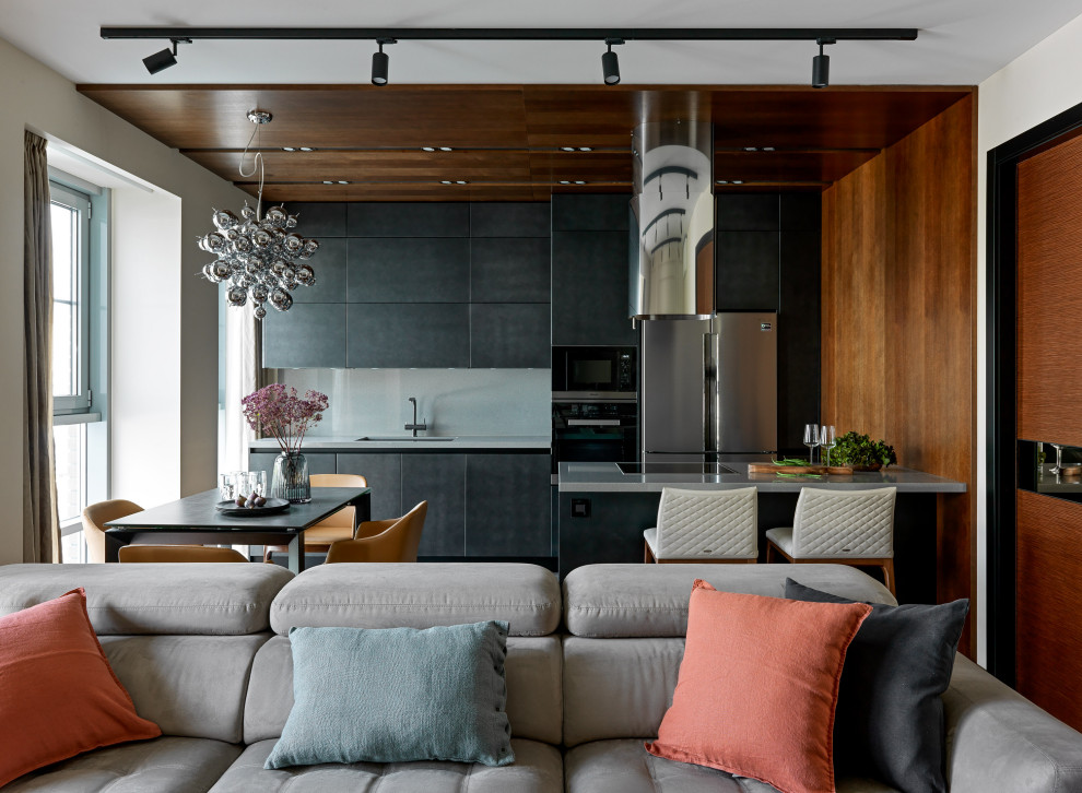 Mid-sized contemporary single-wall eat-in kitchen in Moscow with an undermount sink, flat-panel cabinets, black cabinets, quartz benchtops, grey splashback, porcelain splashback, coloured appliances, porcelain floors, with island, grey floor and grey benchtop.