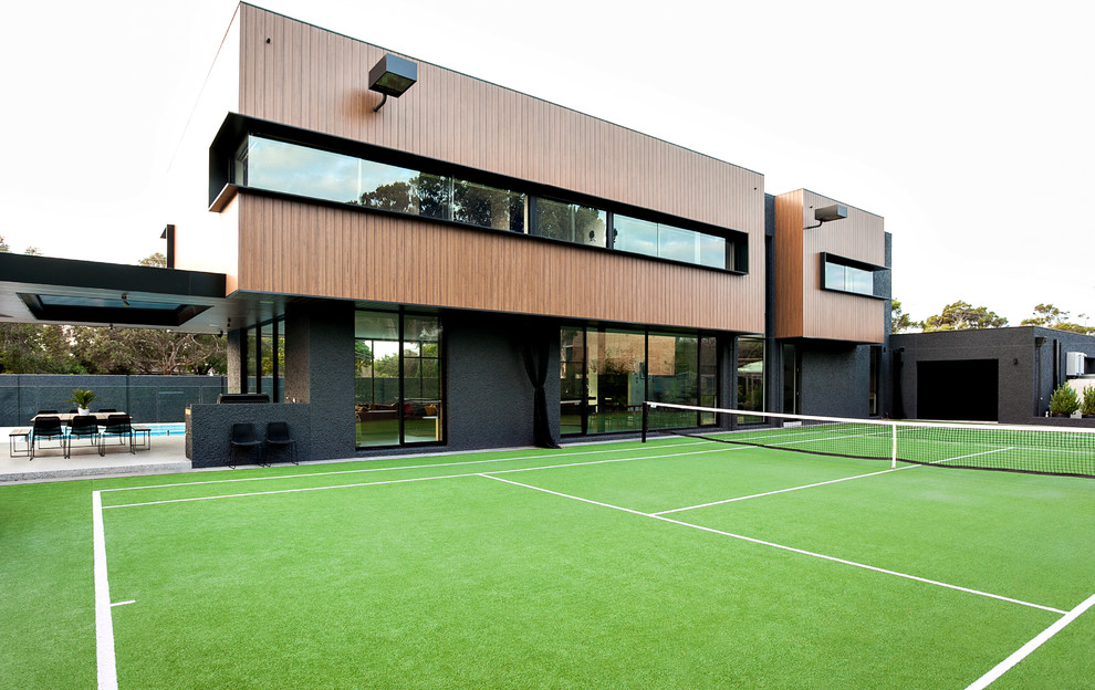 Expansive contemporary two-storey black exterior in Melbourne with wood siding and a flat roof.