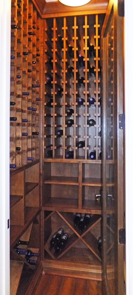 Inspiration for a mid-sized transitional wine cellar in Tampa with light hardwood floors.