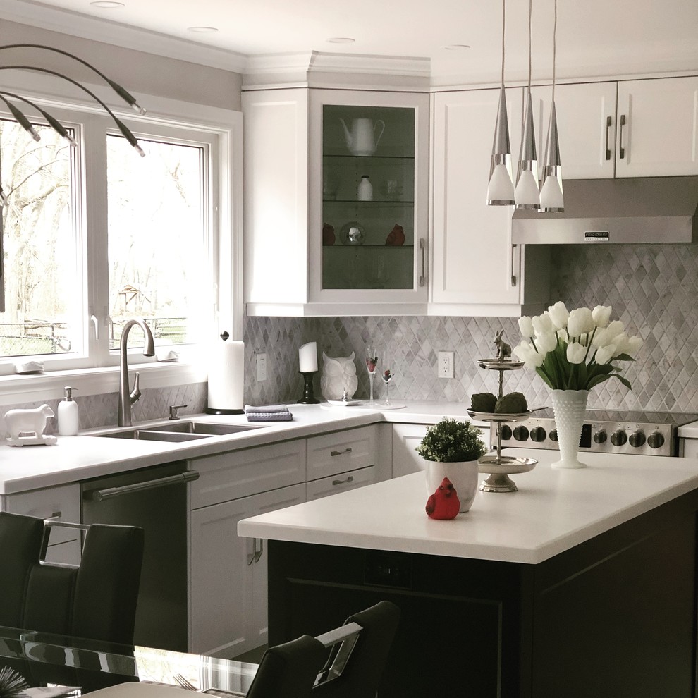 Photo of a modern kitchen in Toronto with shaker cabinets, white cabinets, solid surface benchtops, grey splashback, marble splashback, pink floor and white benchtop.