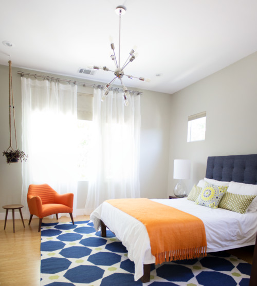 mid century modern bedroom with orange and navy blue color palette, mcm bedroom ideas