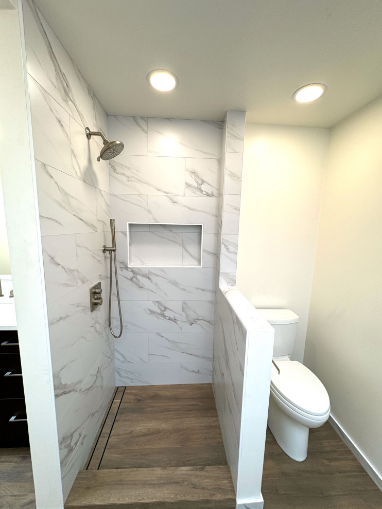Inspiration for a master bathroom in Seattle with a freestanding tub, an open shower, a one-piece toilet, white tile, white walls, light hardwood floors, brown floor, an open shower, a double vanity, a freestanding vanity and wood.