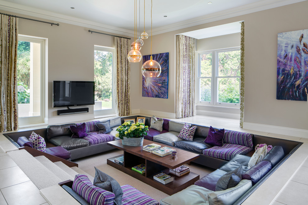 This is an example of a large contemporary family room in Surrey with beige walls, ceramic floors, a wall-mounted tv, beige floor and no fireplace.