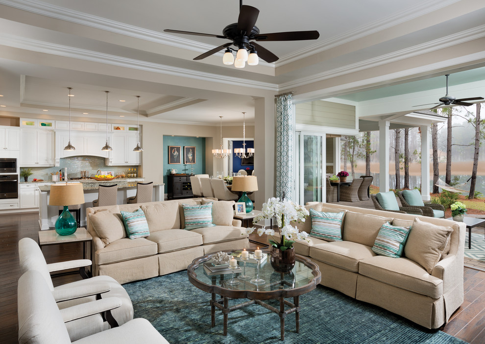 This is an example of an expansive transitional open concept family room in Charleston with beige walls, medium hardwood floors and a wall-mounted tv.