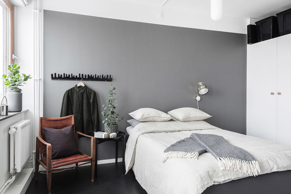 Design ideas for a scandinavian guest bedroom in Stockholm with grey walls and black floor.