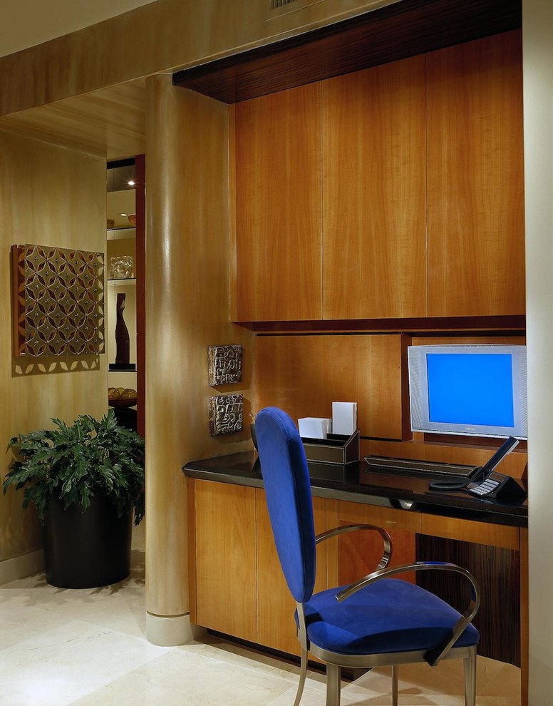 This is an example of a large contemporary home office in Phoenix with travertine floors.