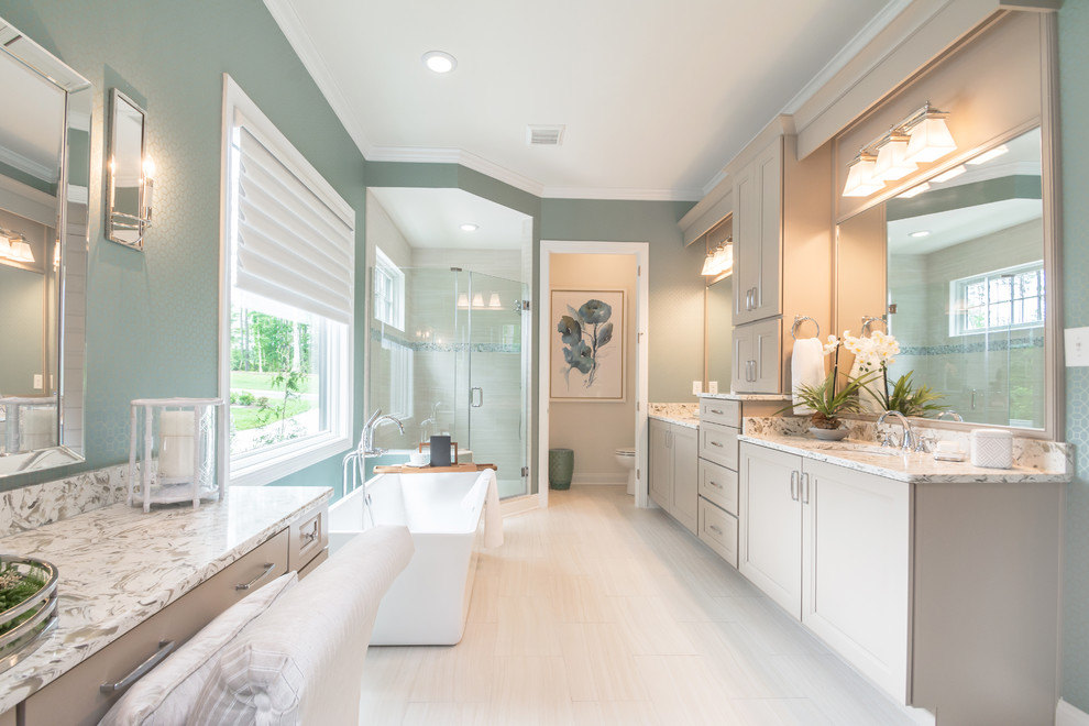 Inspiration for a transitional master bathroom in Other with recessed-panel cabinets, grey cabinets, a freestanding tub, a corner shower, green walls, an undermount sink, beige floor, a hinged shower door and white benchtops.