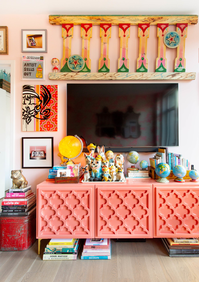 Design ideas for a mid-sized eclectic open concept family room in New York with pink walls and a wall-mounted tv.