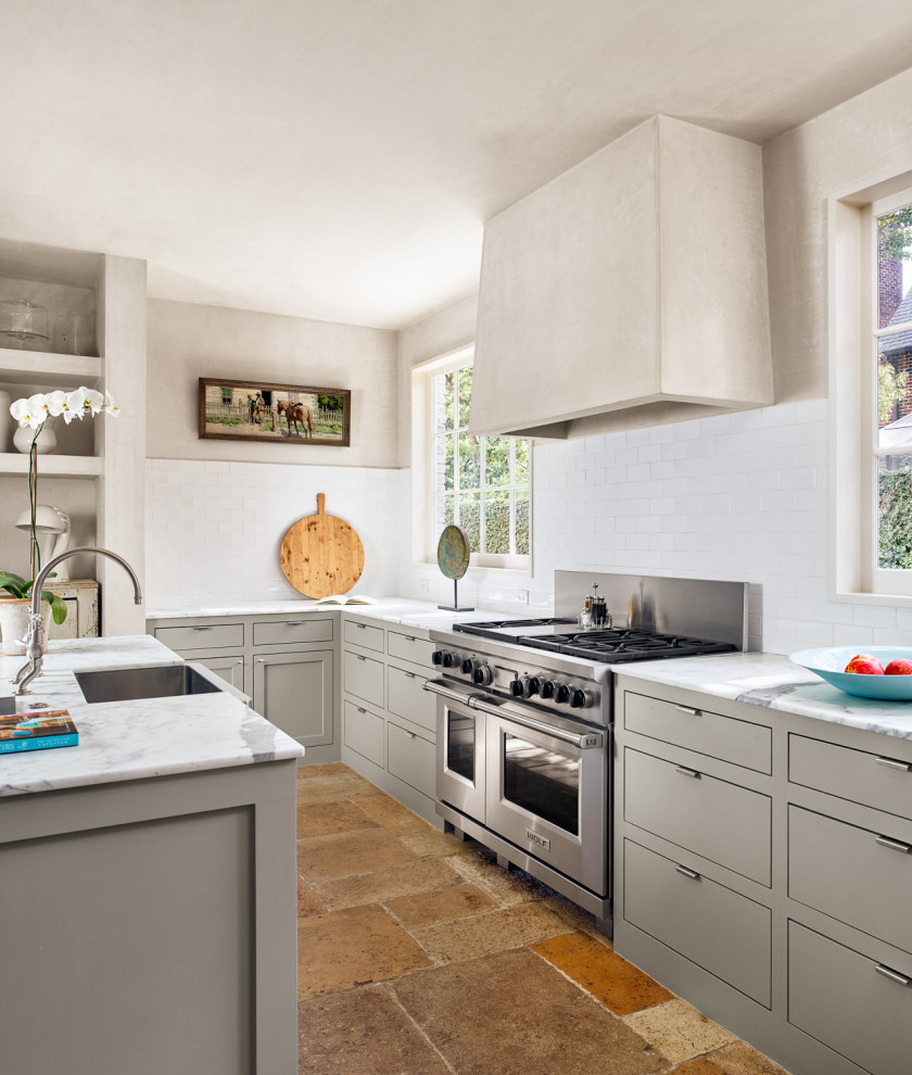 Houston Historic - Enclosed kitchen - large contemporary l-shaped brown floor enclosed kitchen idea in Houston with a drop-in sink, flat-panel cabinets, gray cabinets, white backsplash, stainless steel appliances, an island and white countertops