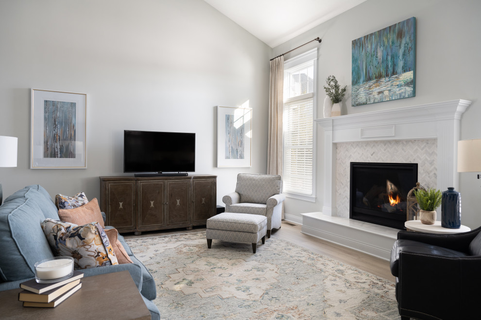 Photo of a mid-sized modern formal enclosed living room in Indianapolis with white walls, dark hardwood floors, a standard fireplace, a concrete fireplace surround and a freestanding tv.
