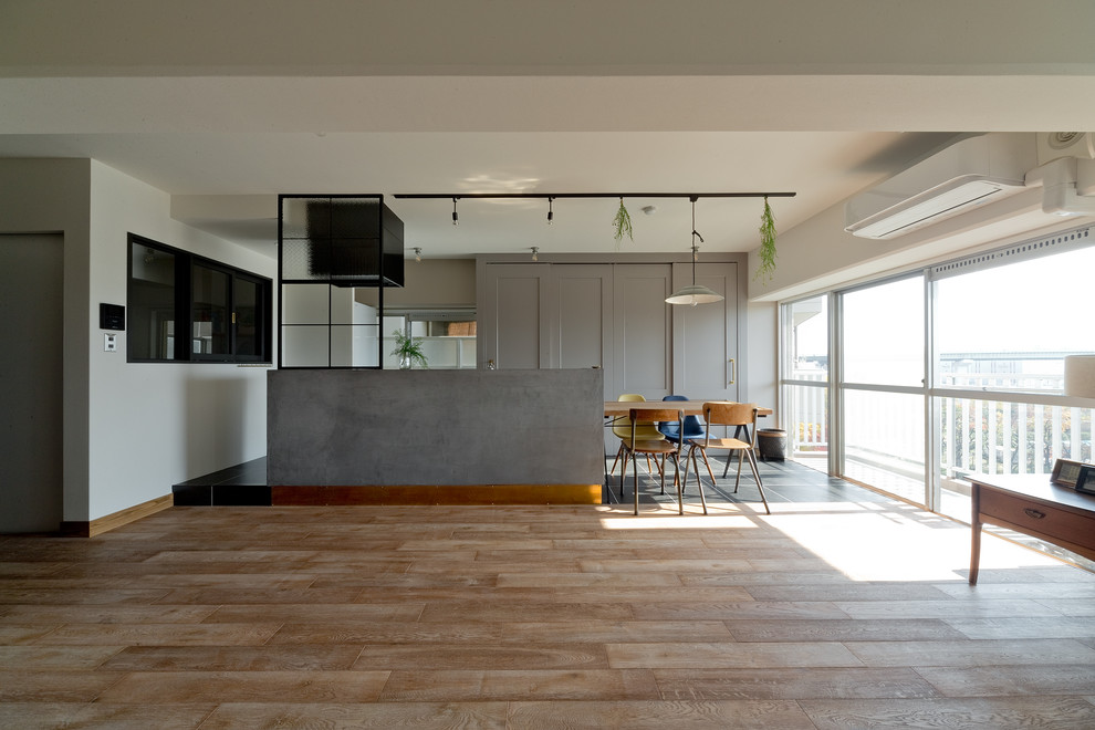 Inspiration for a midcentury open plan dining in Osaka with white walls, medium hardwood floors and no fireplace.