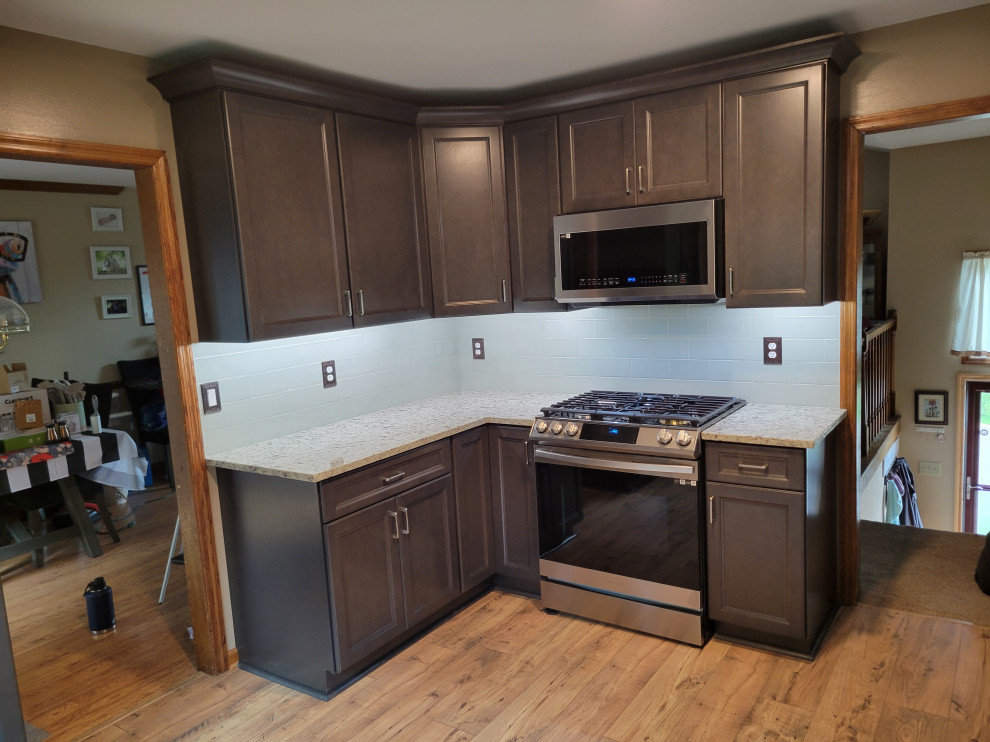 This is an example of a medium sized classic u-shaped kitchen pantry in Nashville with shaker cabinets, dark wood cabinets and granite worktops.