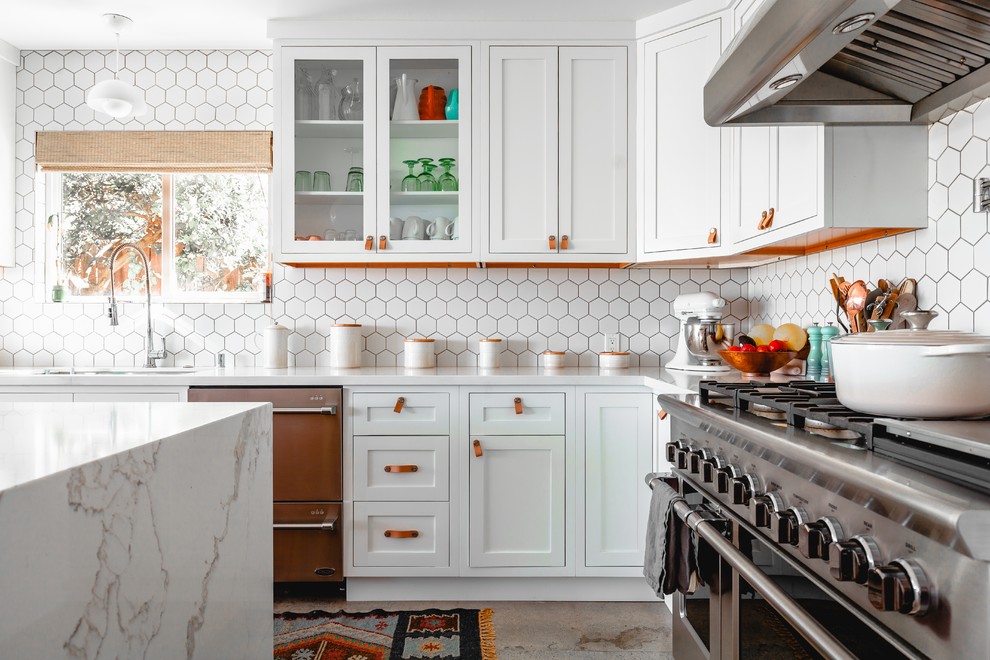 Example of a transitional l-shaped gray floor kitchen design in San Diego with an undermount sink, shaker cabinets, white cabinets, white backsplash, stainless steel appliances, an island and white countertops
