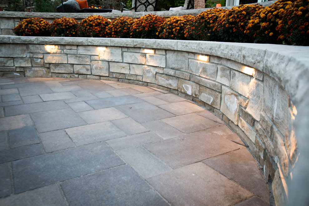 Design ideas for a transitional backyard stone water fountain landscape in Omaha.