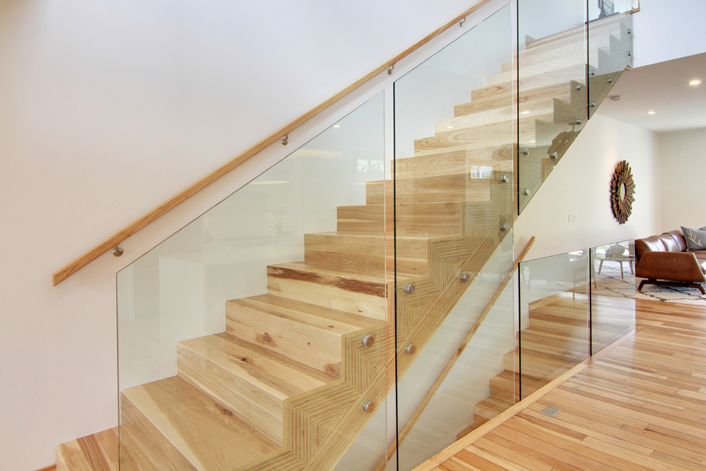 Design ideas for a mid-sized contemporary wood straight staircase in Calgary with wood risers and wood railing.