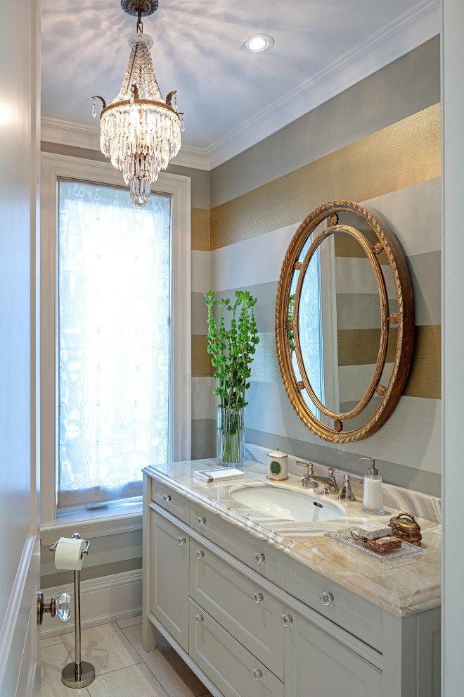 Example of a classic wallpaper powder room design in Toronto with recessed-panel cabinets, white cabinets, multicolored walls, an undermount sink, beige countertops and a freestanding vanity