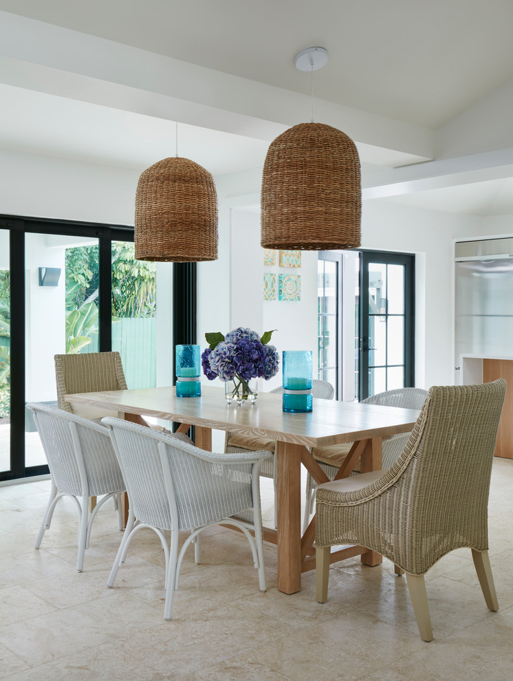 Beach style dining room in Miami with white walls.