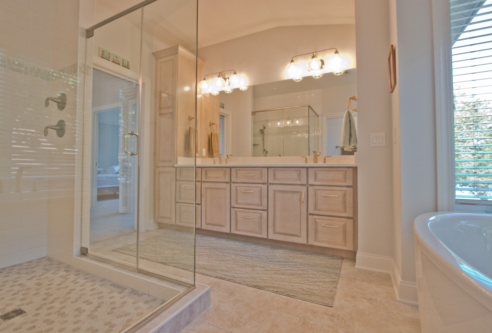 Inspiration for a traditional master bathroom in Other with raised-panel cabinets, beige cabinets, a freestanding tub, a corner shower, white walls, an undermount sink, engineered quartz benchtops, beige floor, a hinged shower door, beige benchtops, an enclosed toilet and a double vanity.