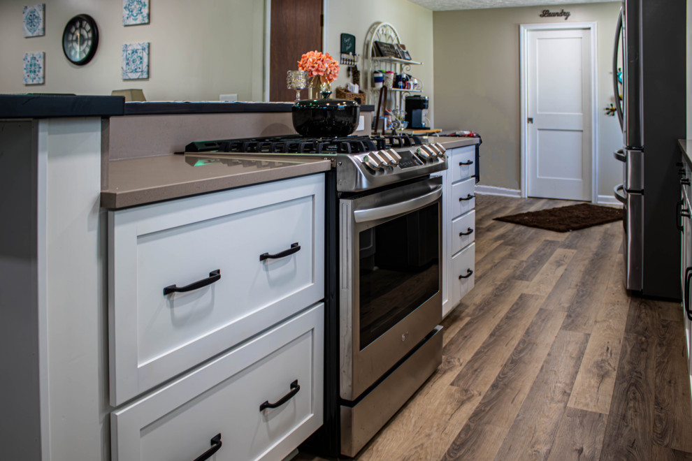 White Kitchen with Blue Tiled Backsplash and Two Tier Island