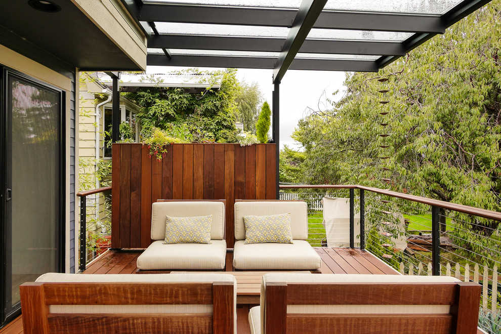 Photo of a contemporary deck in Seattle with a pergola.