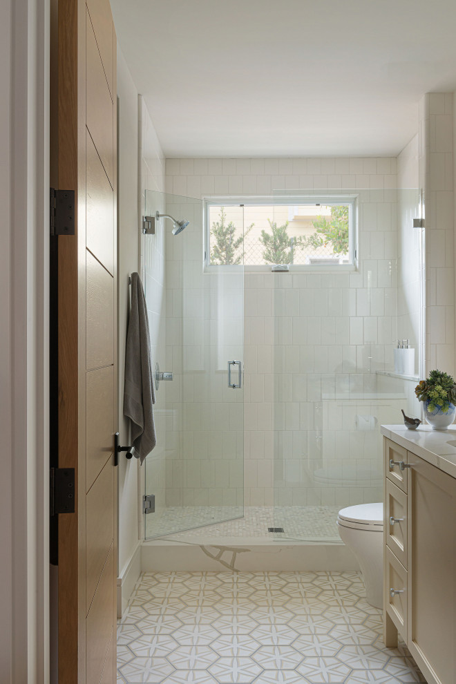 Inspiration for a mid-sized transitional kids' white tile and porcelain tile cement tile floor and single-sink alcove shower remodel with flat-panel cabinets, yellow cabinets, a one-piece toilet, an undermount sink, quartz countertops, a hinged shower door, white countertops and a freestanding vanity