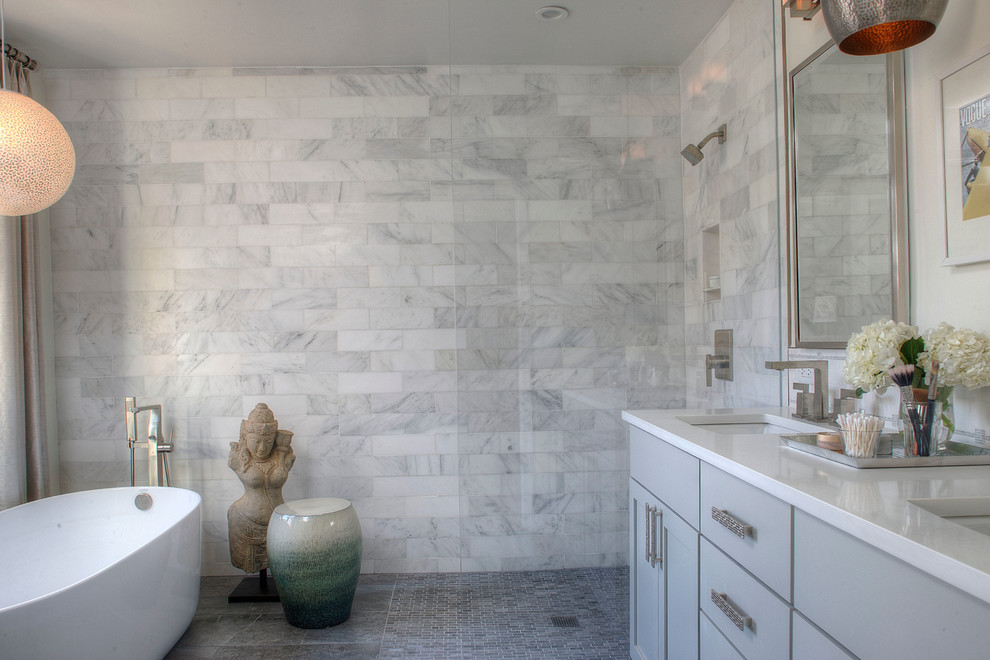 Design ideas for a mid-sized transitional master bathroom in Philadelphia with shaker cabinets, grey cabinets, a freestanding tub, an open shower, a one-piece toilet, gray tile, stone tile, white walls, porcelain floors, an undermount sink and engineered quartz benchtops.