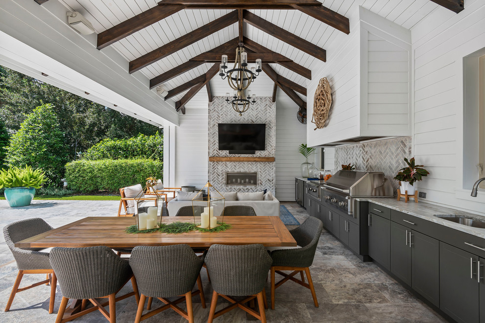 Beach style patio in Orlando with a roof extension.