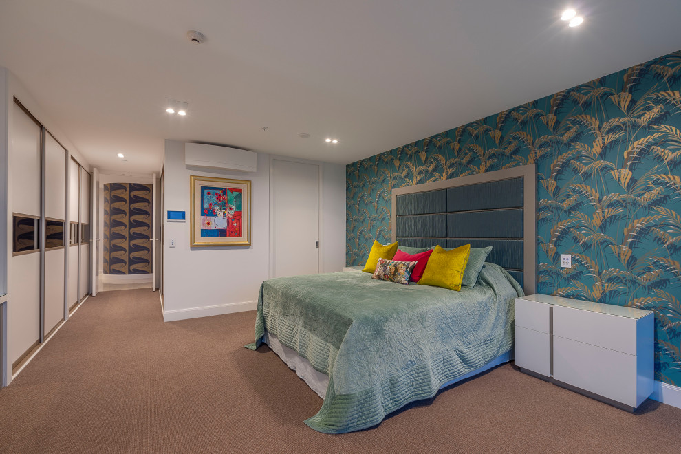 Example of a large trendy master carpeted, pink floor and wallpaper bedroom design in Auckland with gray walls