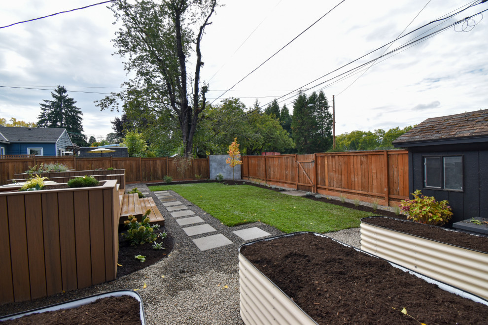 Photo of a large full sun backyard concrete paver and wood fence lawn edging in Portland for fall.