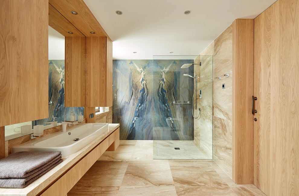 Large contemporary master bathroom in Other with a curbless shower, beige walls, a vessel sink, flat-panel cabinets, light wood cabinets, blue tile, stone slab and an open shower.