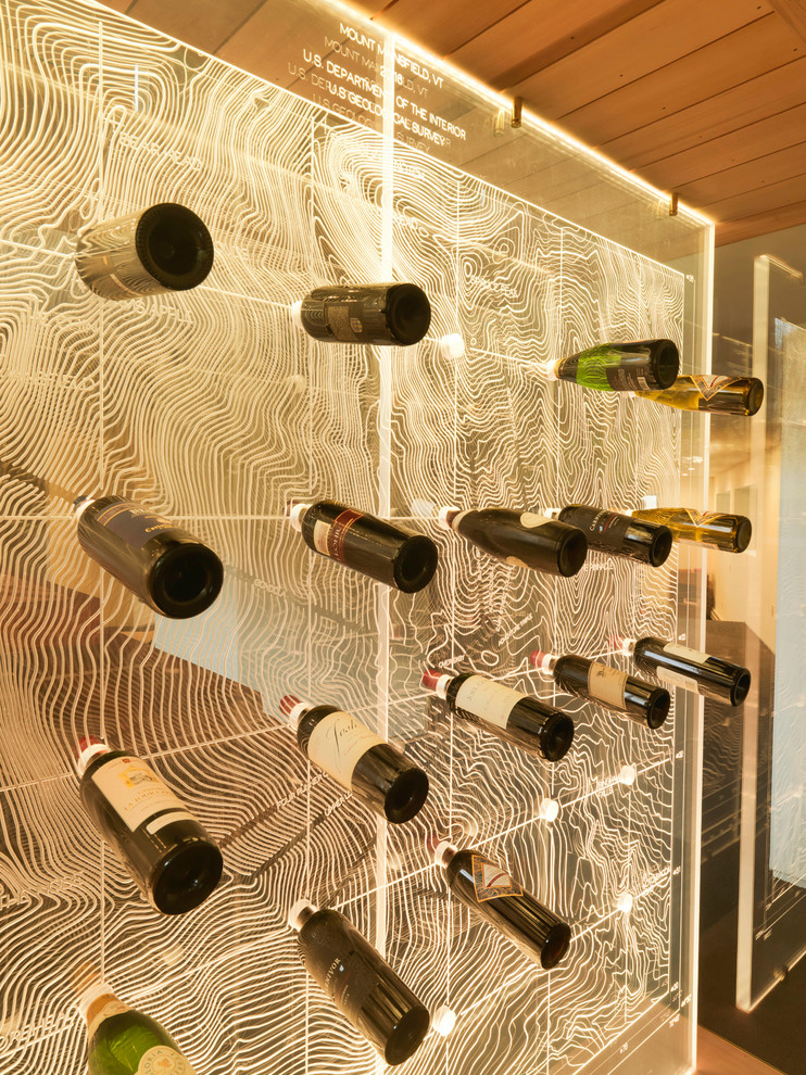 Design ideas for a contemporary wine cellar in Burlington with display racks.