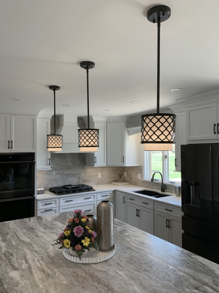 Eat-in kitchen - large transitional l-shaped vinyl floor and gray floor eat-in kitchen idea with an undermount sink, recessed-panel cabinets, white cabinets, quartz countertops, gray backsplash, ceramic backsplash, stainless steel appliances, an island and white countertops