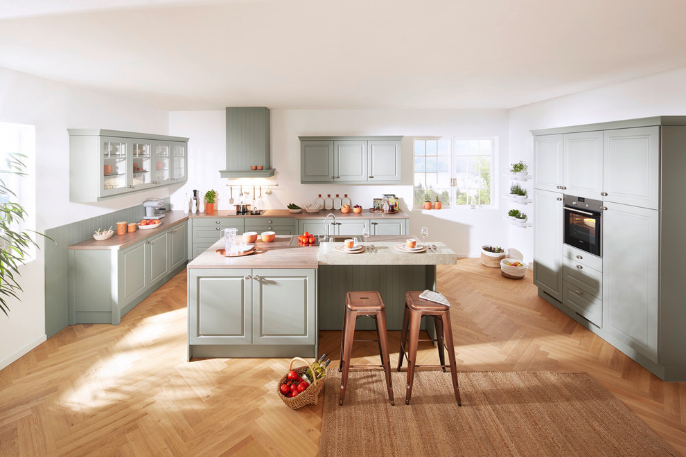 Design ideas for a large traditional open plan kitchen in Stuttgart with green cabinets and with island.