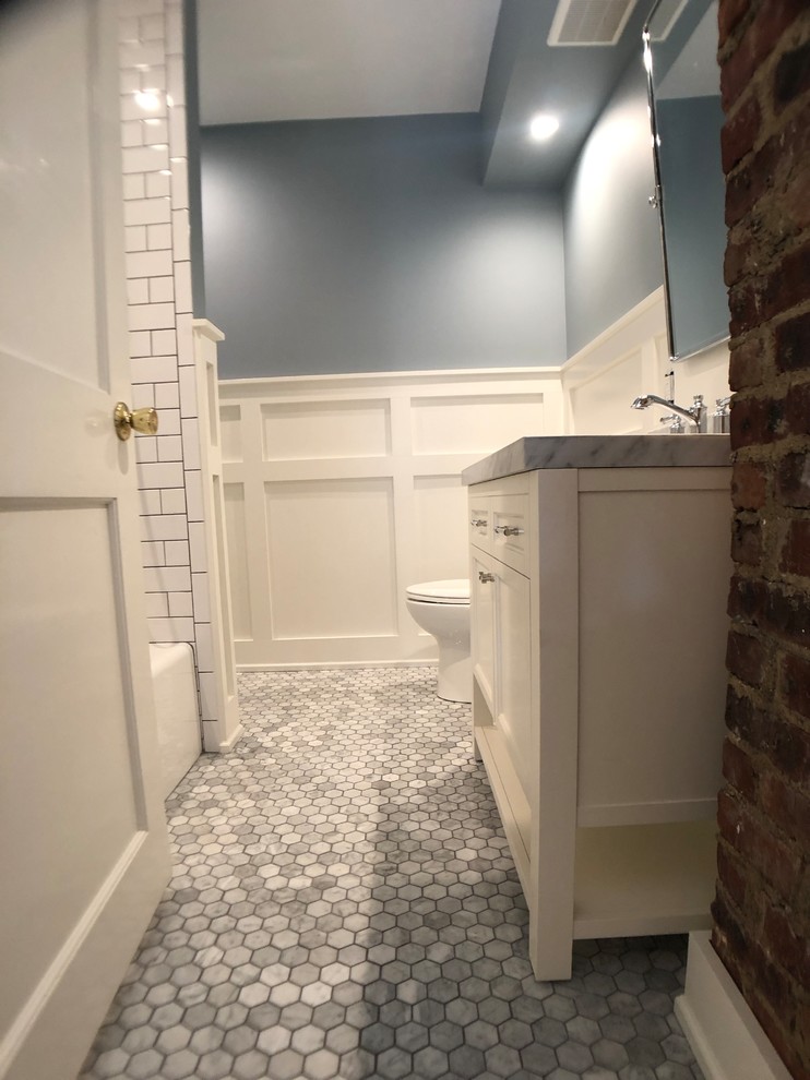 Inspiration for a modern bathroom in New York with a shower/bathtub combo and subway tile.