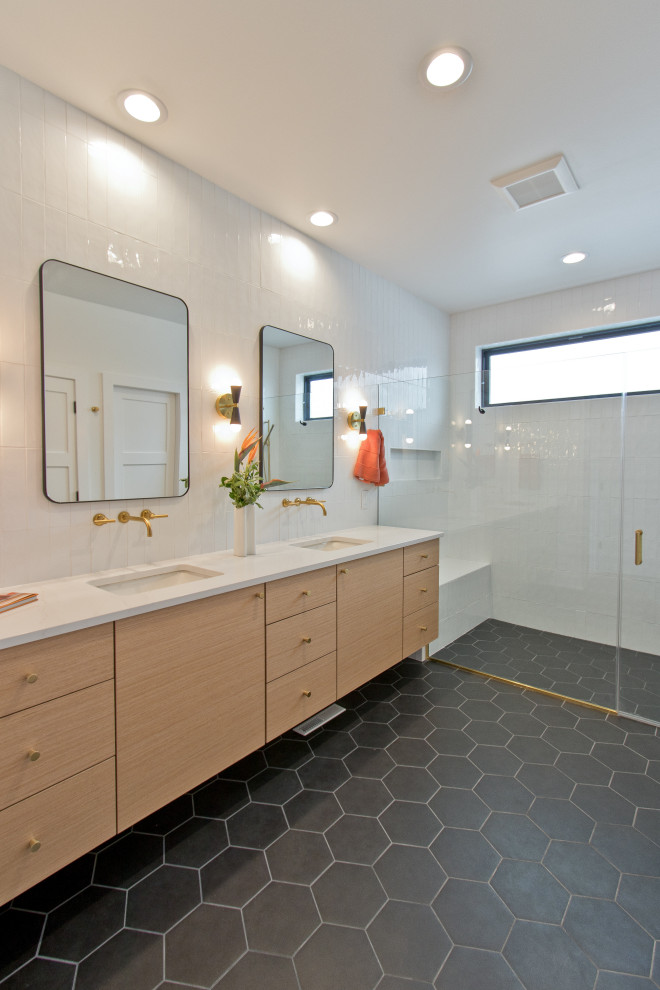 This is an example of a midcentury master bathroom in Other with flat-panel cabinets, light wood cabinets, a curbless shower, white tile, ceramic tile, white walls, porcelain floors, an undermount sink, engineered quartz benchtops, black floor, a hinged shower door, white benchtops, a shower seat, a double vanity and a floating vanity.