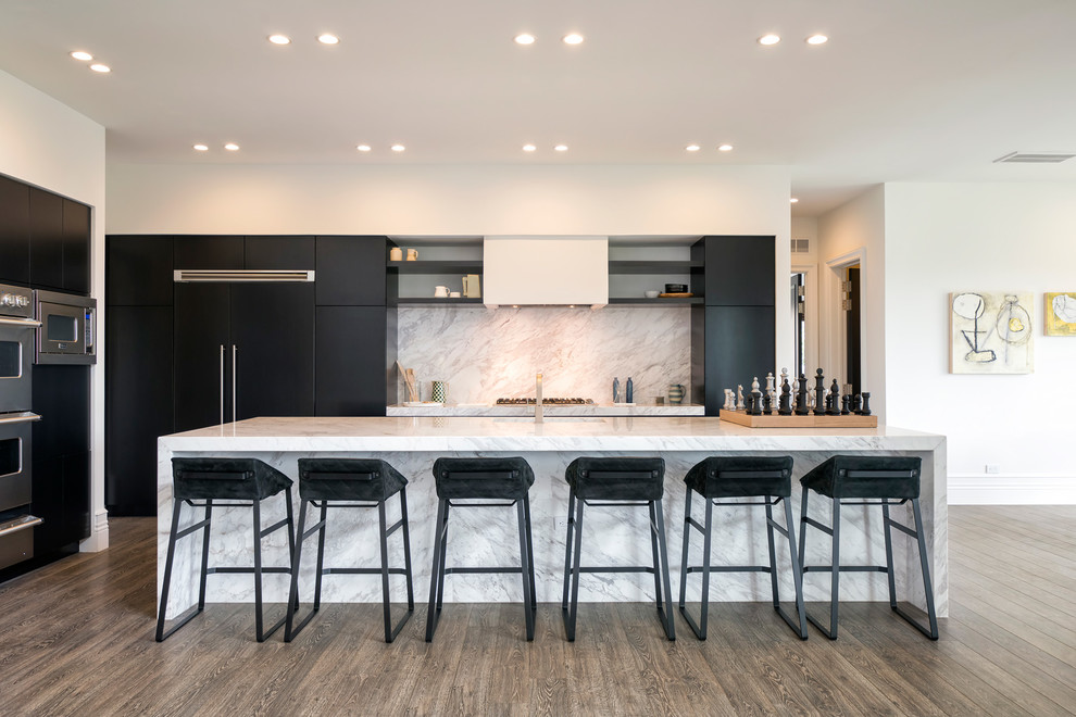 Photo of a mid-sized scandinavian galley open plan kitchen in DC Metro with flat-panel cabinets, black cabinets, white splashback, panelled appliances, with island and marble splashback.
