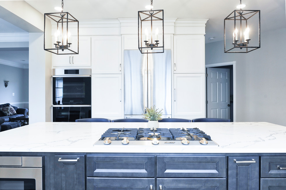 Eat-in kitchen - huge transitional galley brown floor and light wood floor eat-in kitchen idea in DC Metro with an undermount sink, beaded inset cabinets, white cabinets, quartzite countertops, white backsplash, marble backsplash, stainless steel appliances, an island and white countertops