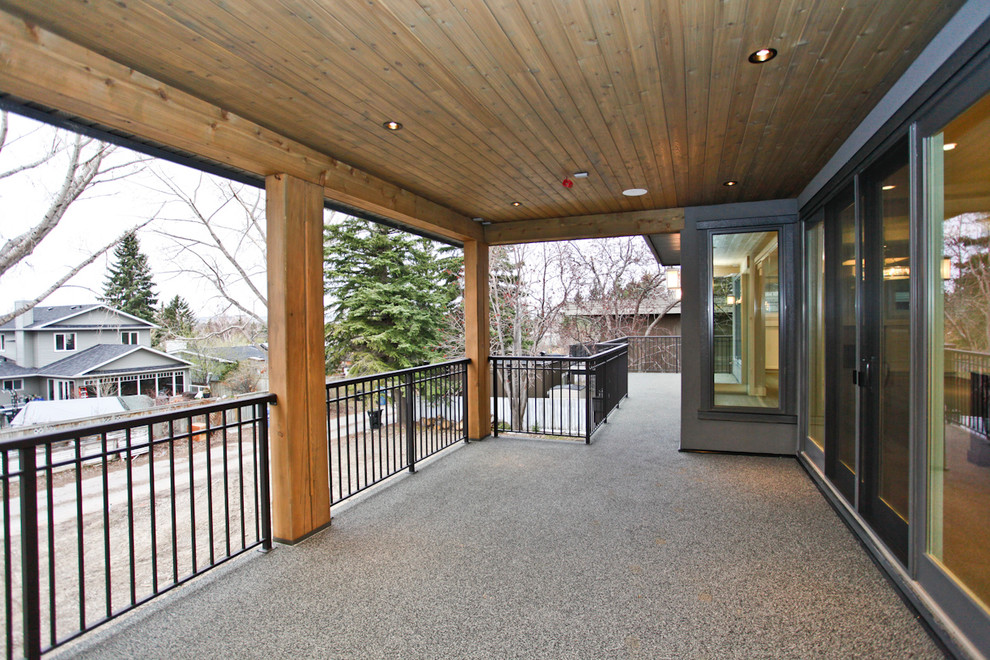 Large arts and crafts backyard patio in Calgary with an outdoor kitchen and a roof extension.