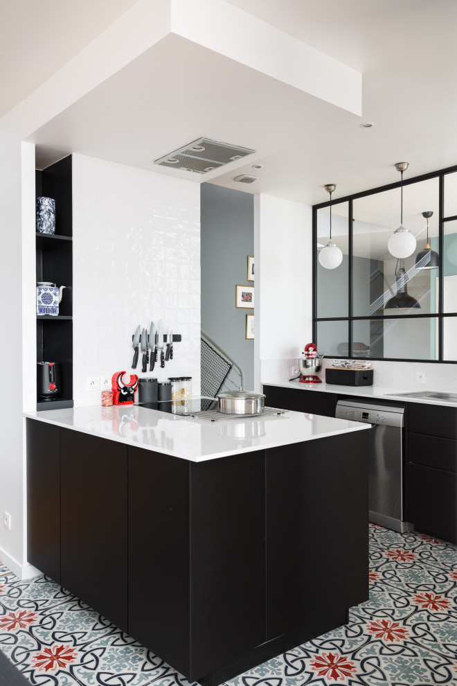 Small contemporary galley kitchen in Paris with an undermount sink, flat-panel cabinets, white splashback, stainless steel appliances, with island, multi-coloured floor and white benchtop.