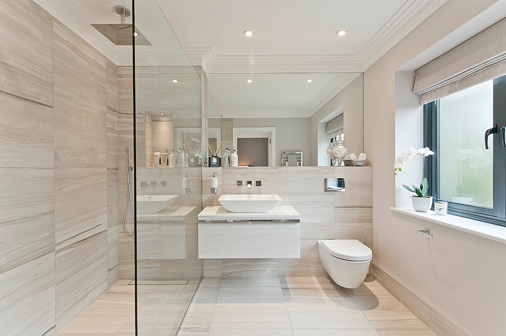 This is an example of a contemporary bathroom in Surrey with a curbless shower, a wall-mount toilet and a vessel sink.