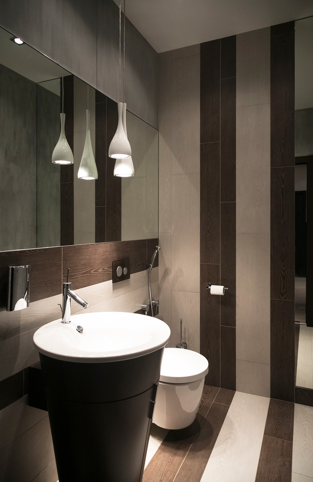Small contemporary 3/4 bathroom in Moscow with dark wood cabinets, a wall-mount toilet, beige tile, porcelain tile, beige walls, porcelain floors, a pedestal sink and glass benchtops.