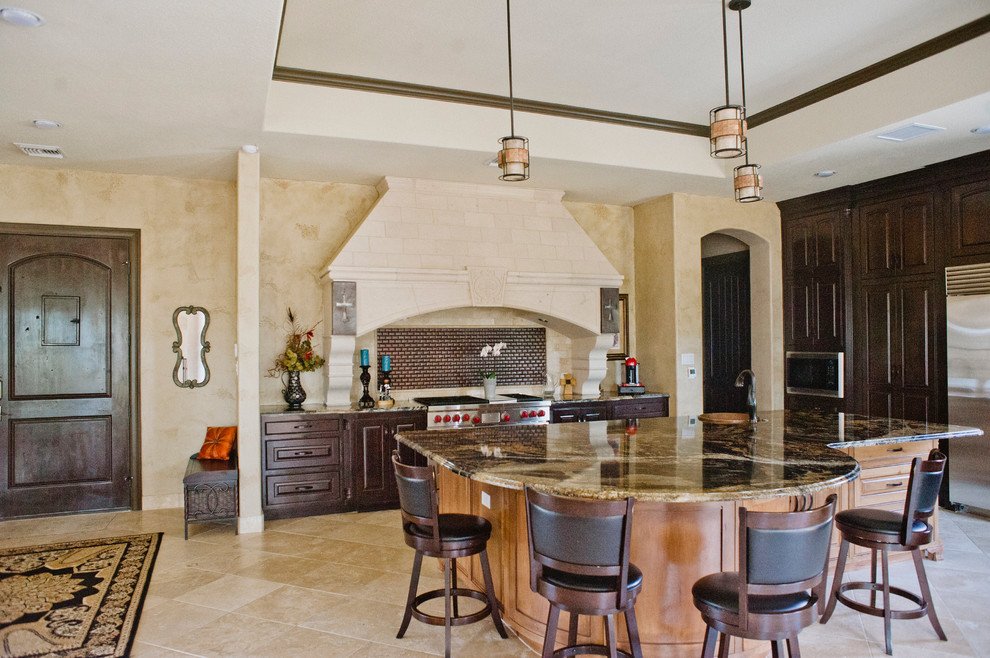 This is an example of an expansive galley eat-in kitchen in Austin with a double-bowl sink, granite benchtops, metallic splashback, metal splashback, stainless steel appliances, travertine floors and with island.