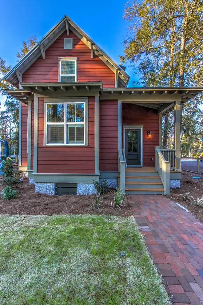 Photo of a small traditional two-storey red exterior in Atlanta with concrete fiberboard siding and a gable roof.