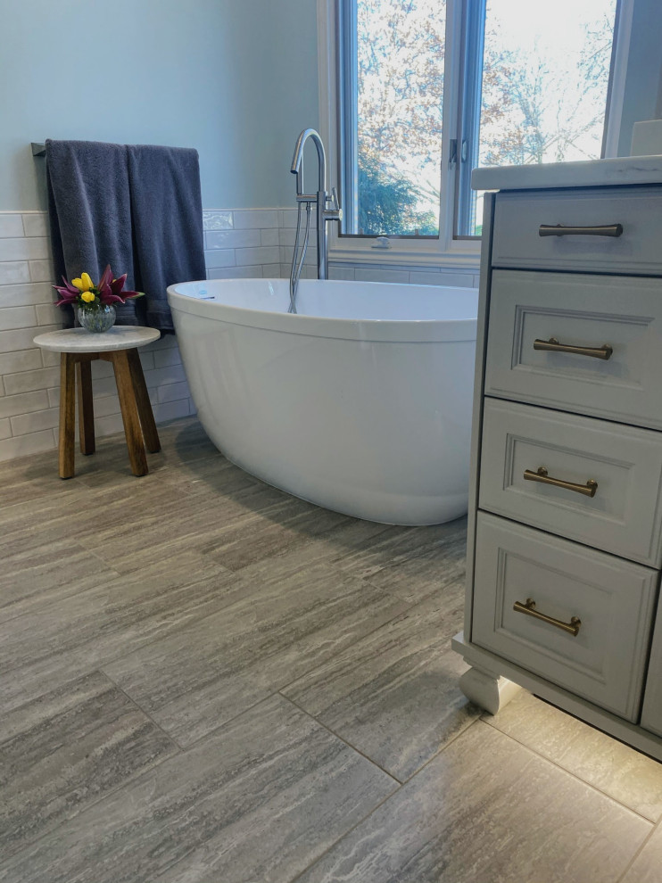 Bathroom - mid-sized transitional master white tile and subway tile porcelain tile, gray floor and single-sink bathroom idea in Wichita with flat-panel cabinets, white cabinets, a two-piece toilet, blue walls, an undermount sink, quartz countertops, white countertops and a built-in vanity
