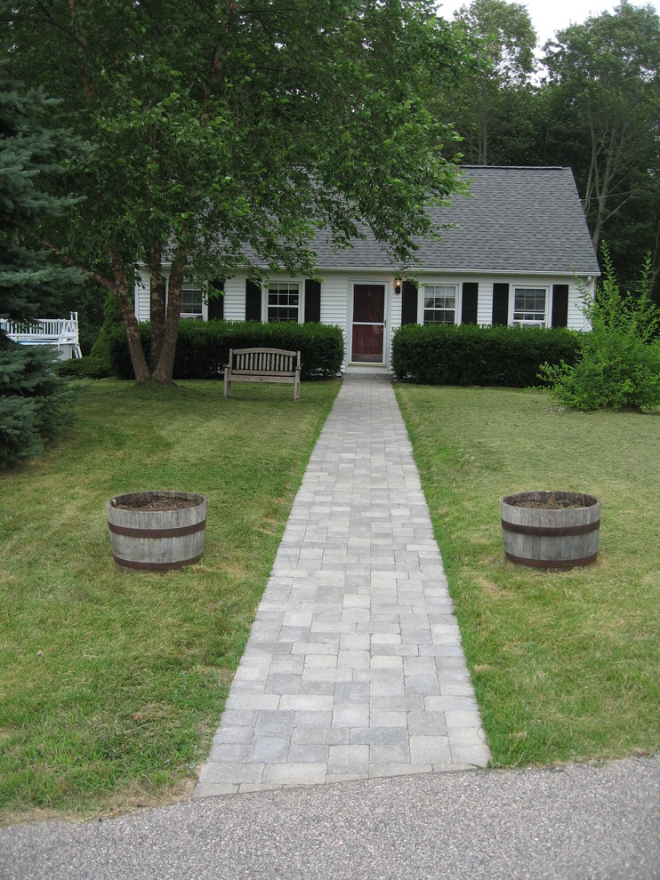 This is an example of a mid-sized traditional front yard partial sun garden in Providence with a garden path and brick pavers.