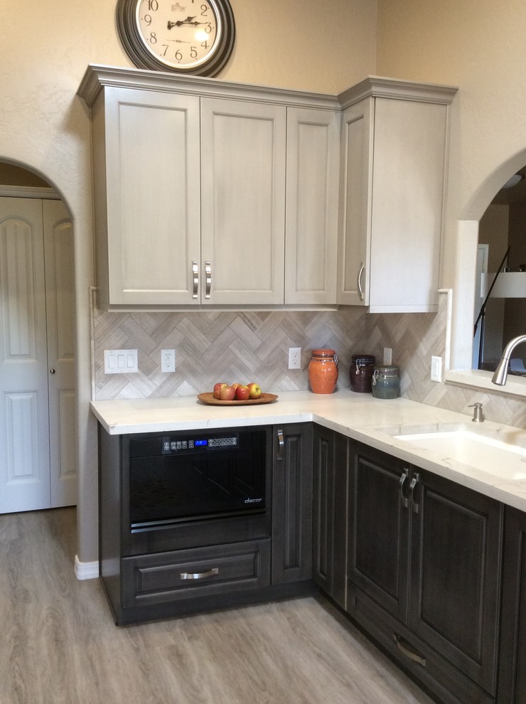 Mid-sized transitional dark wood floor and brown floor kitchen photo in Phoenix with a single-bowl sink, raised-panel cabinets, dark wood cabinets, onyx countertops, brown backsplash, ceramic backsplash, stainless steel appliances and an island