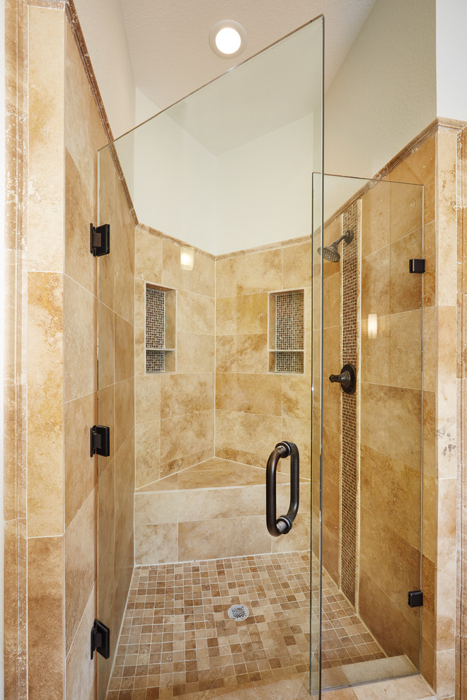 Mid-sized mediterranean master bathroom in Dallas with flat-panel cabinets, dark wood cabinets, a drop-in tub, an alcove shower, a one-piece toilet, beige tile, stone tile, white walls, ceramic floors, an undermount sink, granite benchtops, beige floor and a hinged shower door.