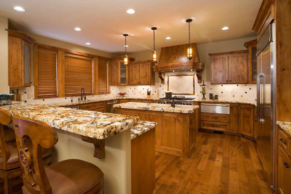 Kitchen - rustic u-shaped medium tone wood floor kitchen idea with an undermount sink, shaker cabinets, medium tone wood cabinets, granite countertops, beige backsplash, ceramic backsplash, stainless steel appliances and an island