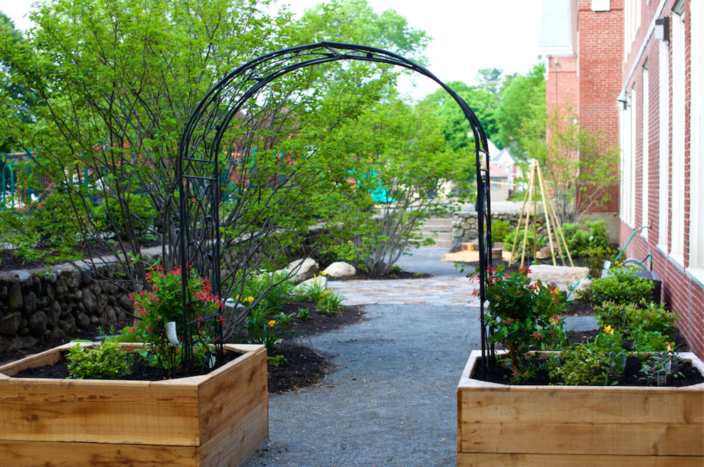 Design ideas for a mid-sized contemporary partial sun side yard stone vegetable garden landscape in Boston.