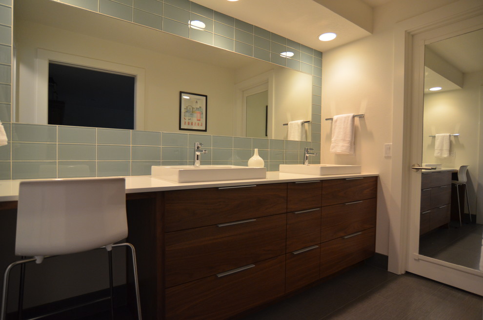 This is an example of a large modern master bathroom in Portland with a vessel sink, flat-panel cabinets, dark wood cabinets, engineered quartz benchtops, a double shower, green tile, glass tile, white walls and ceramic floors.